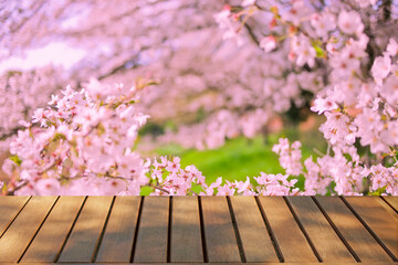 wooden table with cherry blossom background