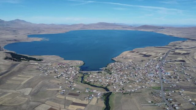 Discover Paravani,  largest lake in Georgia, Samtskhe-Javakheti region. 4K drone shot captures the stunning sunset over this volcanic landscape, also known as Georgian Arctic.