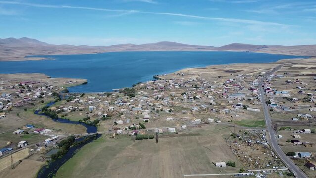 Discover Paravani,  largest lake in Georgia, Samtskhe-Javakheti region. 4K drone shot captures the stunning sunset over this volcanic landscape, also known as Georgian Arctic.