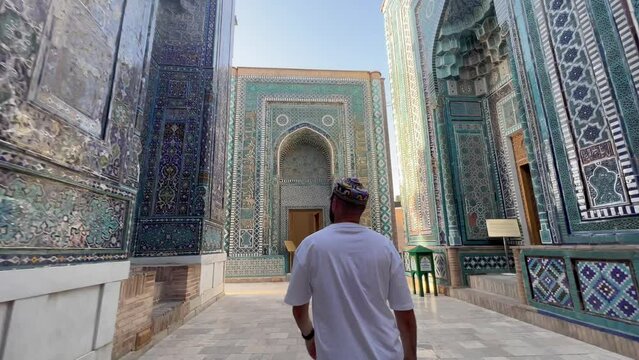 Young Man Admires Mausoleum of Khoja Ahmad at Shah-i-Zinda, Samarkand, Uzbekistan; 4K Footage Highlights Persian-Mongolian Architecture, Vibrant Tiles, and Silk Road History in a UNESCO Site.