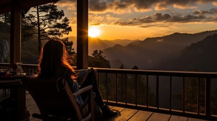 a female traveler sitting and looking at a beautiful sunrise on foggy day - obrazy, fototapety, plakaty
