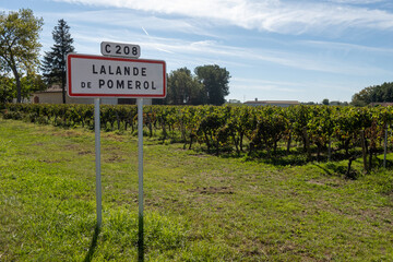 City road sign Lalande de Pomerol near Saint-Emilion wine making region, growing of Merlot or Cabernet Sauvignon red wine grapes, France, Bordeaux
