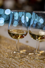 Small tasting glasses of sparkling wine champagne on winter festival in December, Avenue de Champagne, Epernay, Champagne region, France
