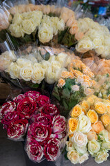 Many roses in bouquets for sale in floral boutique shop in France
