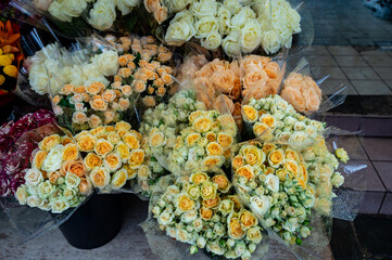 Many roses in bouquets for sale in floral boutique shop in France