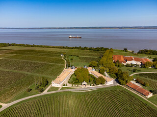 Aerial view on vineyards, Gironde river, wine domain or chateau in Haut-Medoc red wine making...