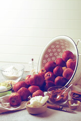 Baking ingredients: red apples, eggs, brown sugar, oatmeal, coconut oil, walnuts, salt, rice flour and spices. Home cooking concept. Retro style photo, copy space