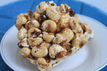 Indonesian snack called brondong made of corn in a white plate on the table