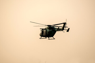helicopter flying on isolated sky during dawn