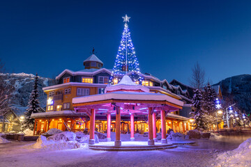 Festive Whistler village at night in winter with snow and Christmas light
