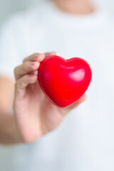 hand holding red heart shape in hospital. love, donor, world heart day, world health day, CSR donation and Insurance concepts