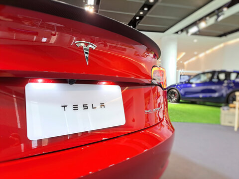Tesla car showroom with logo sign Automotive Clean Energy company TSLA designs and manufactures  electric vehicle : Bangkok, Thailand - Oct 24, 2023