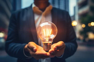 Foto op Plexiglas Inspirational thoughts Human hand holds a light bulb for lighting. Ideas for creativity and inspiration for sustainable business development and success generative by ai © Wayu
