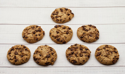 Cookies with chocolate chips isolated on wooden background.