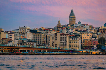 Sunrise cityscape of the Karakoy area across Bosphorus Strait by Galata Bridge with the Galata Tower at the golden hour of sunrise in Istanbul, Turkey