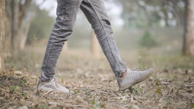 Young Boy Walking Tree Forest, Sad Boy Walking On Forest, legs of a person in a forest stock video