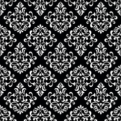 Floral pattern. Vintage wallpaper in the Baroque style. Seamless vector background. White and black ornament for fabric, wallpaper, packaging. Ornate Damask flower ornament