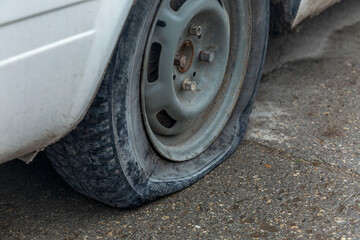 A flat tire on an old car. Maintenance and insurance. Close-up.