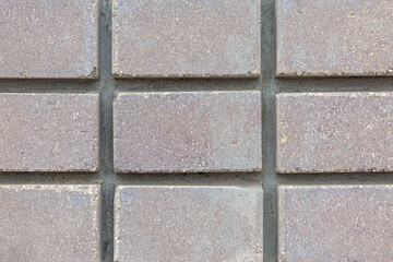 Squares of gray decorative tiles. Construction and repair. Close-up. Background. Space for text.
