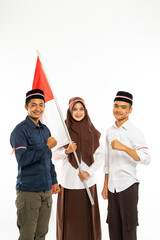 a beautiful islamic student in white shirt and brown veil with the indonesian flag at her hand standing between the male students clenched their arm and smiling