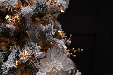 close-up of decorated white and gold flocked christmas tree