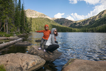Fototapeta na wymiar Mother and child enjoying a lakeside adventure together