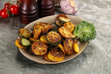 Roasted young zucchini in the plate