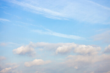 A beautiful sky tinted by the sun leaving vibrant shades of gold, pink, blue and multicolored. Clouds in the twilight evening and morning sky. Cloudy sky background in the evening and during the day.