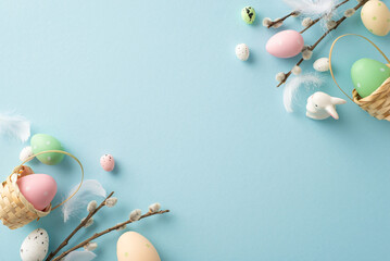 Explore essence of Easter spring with delightful top-view shot featuring colorful eggs in tiny baskets, charming bunny, pussy willow, all set against soft blue background. Perfect for text or advert