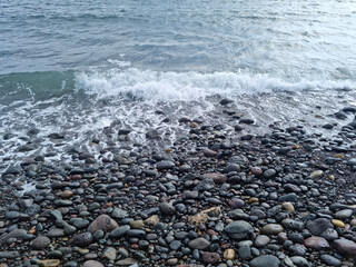 
Jeju Island beach with round basalt rocks.