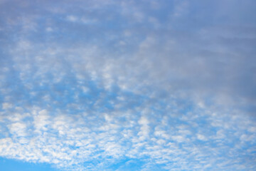 A beautiful sky tinted by the sun leaving vibrant shades of gold, pink, blue and multicolored. Clouds in the twilight evening and morning sky. Cloudy sky background in the evening and during the day.
