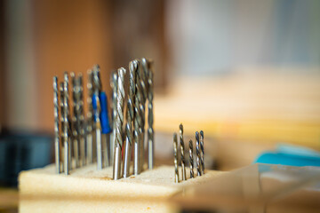 A set of different small drills in a carpentry workshop, close-up. Wood drills