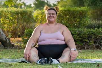 Portrait of a plump woman sitting outdoors meditating