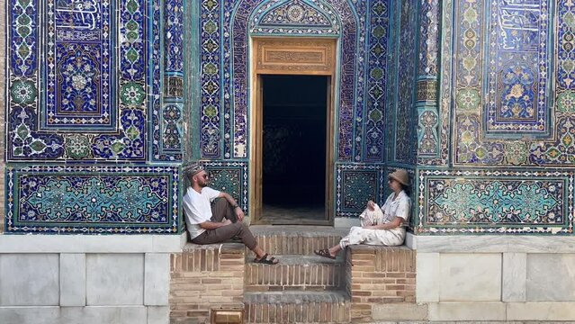Couple Admires Tuman Aqa Mausoleum, Samarkand, Uzbekistan. Dive into Timurid Dynasty's Legacy in UNESCO-listed Shah-i-Zinda. Silk Road's Blend of Persian and Central Asian Influences.