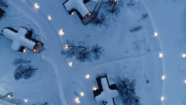 Top View Of Snowhotel Cabins On A Winter Evening In Norway. aerial topdown shot