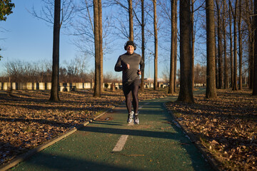 Mature man running in the park with headphones