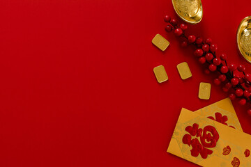 Chinese New Year  festival decorations, golden, flowers, paper fan, Chinese lanterns, envelopes on red background. Flat lay, top view, Text space images