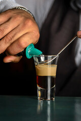 multi-layered cocktail shots at the bar