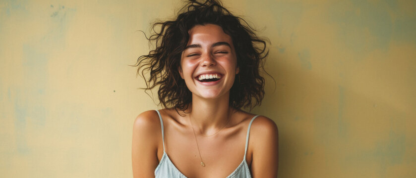 Portrait Of A Beautiful Young Woman Laughing And Looking At The Camera