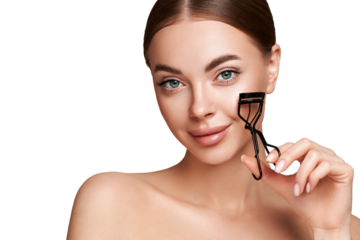 Close up of a beautiful young woman curling her eyelashes. Eyelash extensions