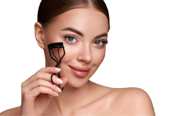 Close up of a beautiful young woman curling her eyelashes. Eyelash extensions