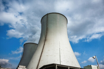 Giant Cooling Towers at Industrial Facility Under Cloudy Sky