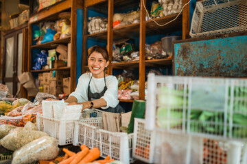 happy vegetable seller arranging her products into basket