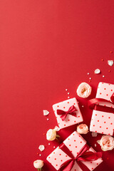 Valentines Day vertical banner design. Flat lay composition with gift boxes, rose buds on red background. Top view.