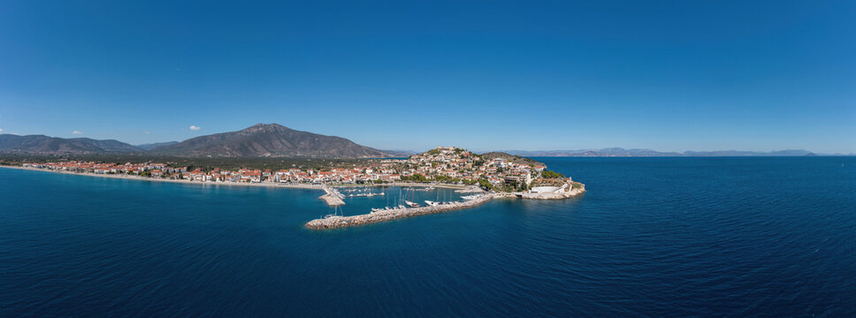 Paralio Astros port, Peloponnese Greece. Aerial drone panoramic view of town, boat, sea, sky. Banner