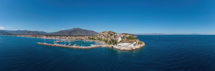 Naklejka na ściany i meble Paralio Astros port, Peloponnese Greece. Aerial drone panoramic view of town, boat, sea, sky. Banner