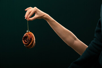 Donuts, bun, croissant Christmas toy on a black background. Creative collage.
