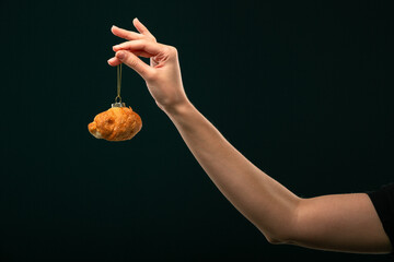 Donuts, bun, croissant Christmas toy on a black background. Creative collage.