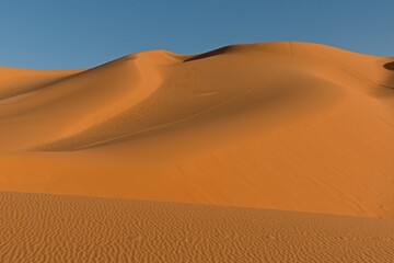 Fototapeta na wymiar View on Dunes of Moul n Aga, Tadrart Rouge rocky mountain range in Tassili n Ajjer National Park. Sahara desert, Algeria, Africa.