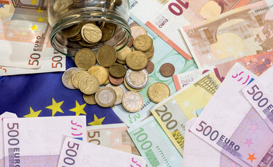 pile of Euro paper with metal coins, close up